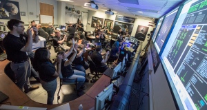 New Horizons Flight Controllers celebrate after they received confirmation from the spacecraft that it had successfully completed the flyby of Pluto, Tuesday, July 14, 2015 in the Mission Operations Center (MOC) of the Johns Hopkins University Applied Physics Laboratory (APL), Laurel, Maryland. Photo Credit: (NASA/Bill Ingalls)